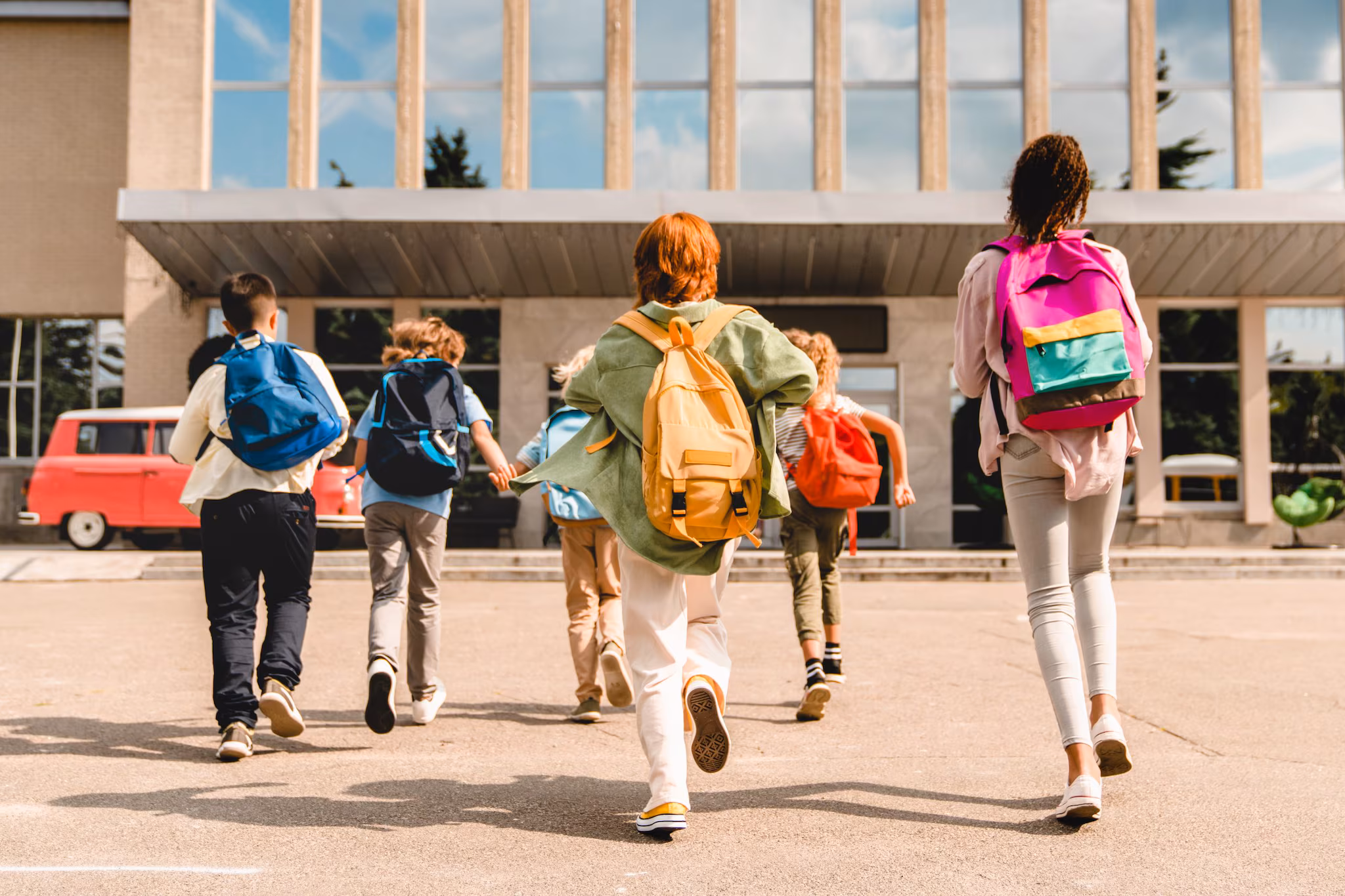 Students walking into a school. Students walking into a school.