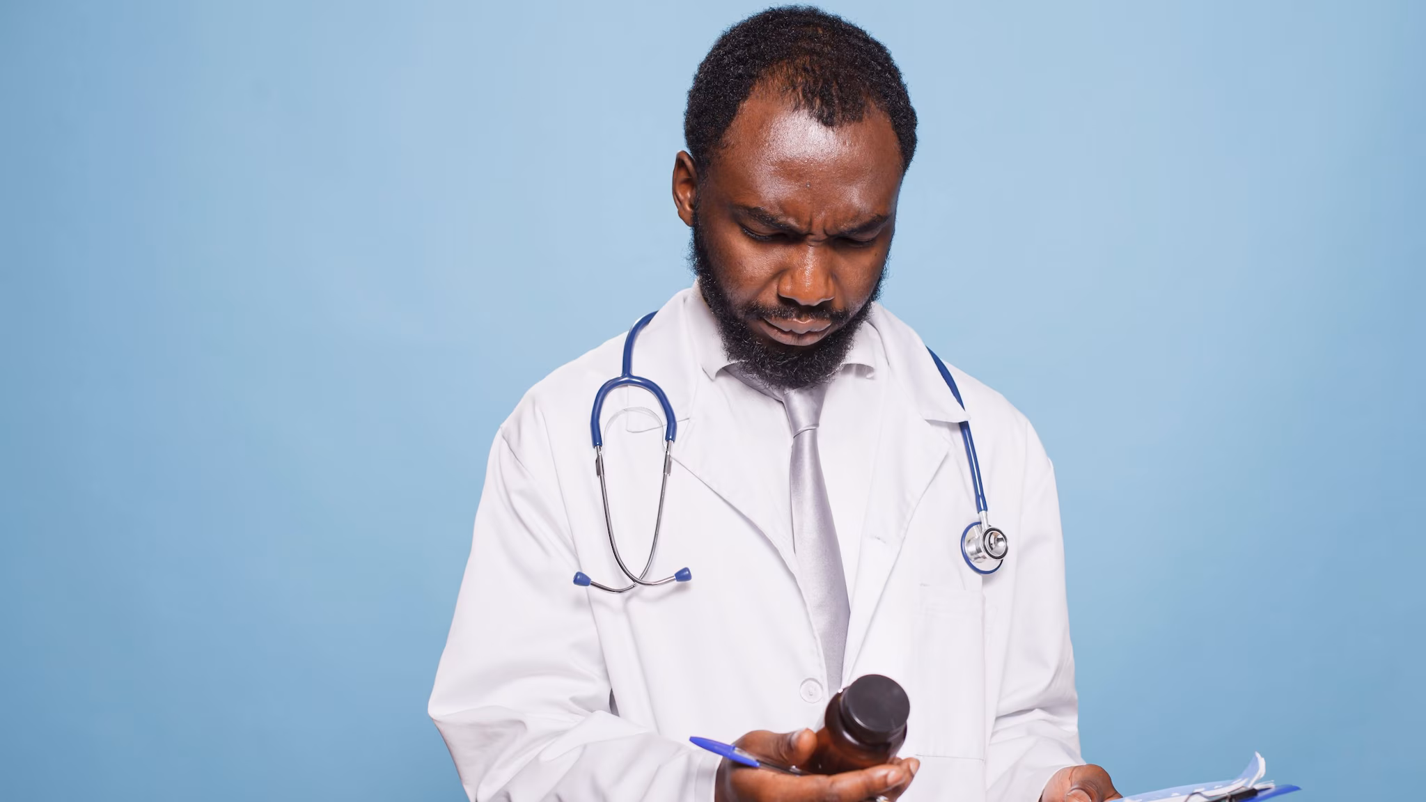Clinician looking at a prescription bottle.