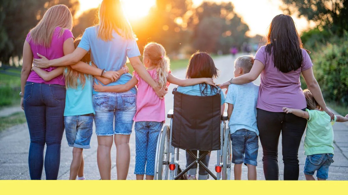 — title missing — A group of children and caregivers with their arms around each other watching the sunset.