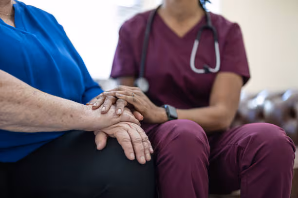 COVID-19 Vaccines for Long-term Care Residents Health care professional comforting long-term care resident.