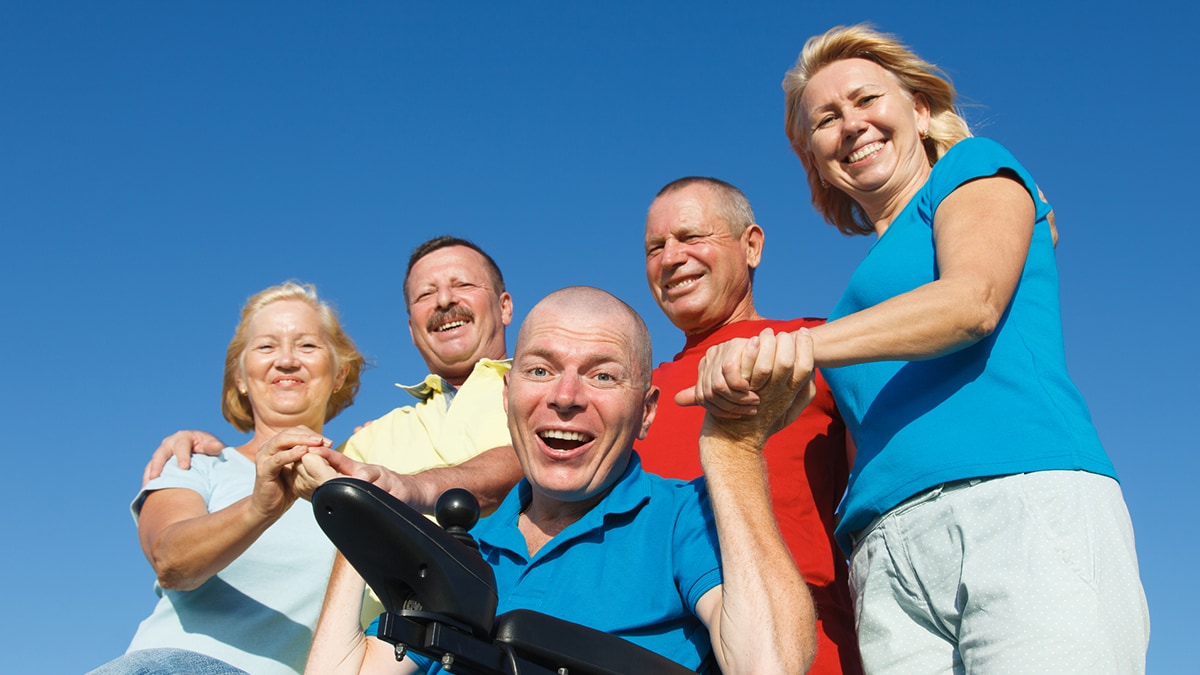 Disabled Man with family outside Man in wheelchair with family outside
