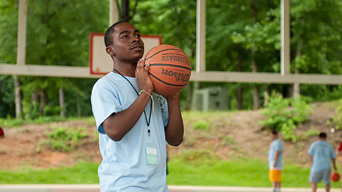 Boy shooting basketball at a park Boy shooting basketball at a park