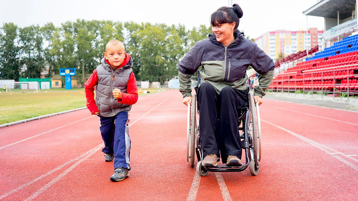 fitness disabilities kids Woman in a wheelchair with a child getting ready to run