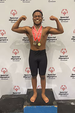 Eric Massey_After-250px Eric Massey displaying his medals at the 2022 Special Olympics USA Games