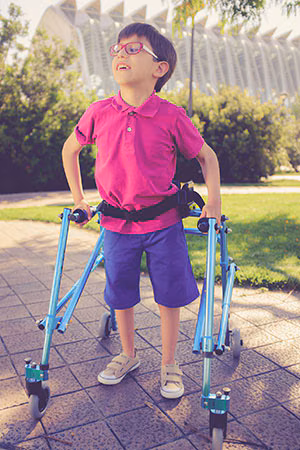 CYSHN Thumbnail A boy using a walker outside.