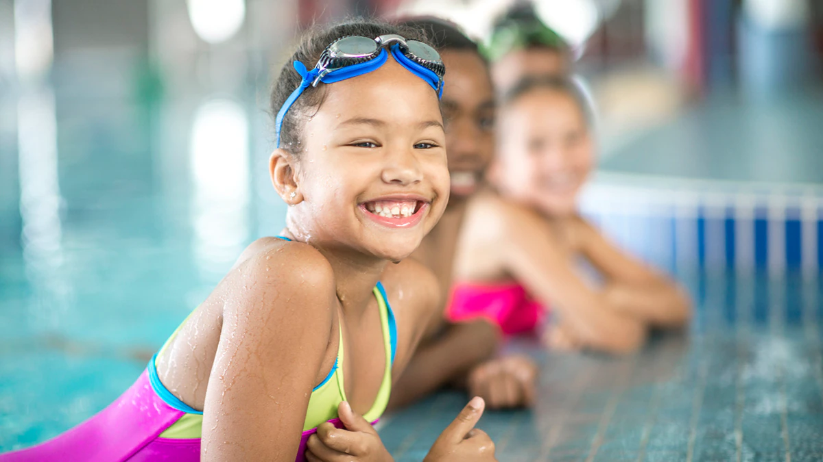 Young girl in swim lesson Young girl in swim lesson on pool edge