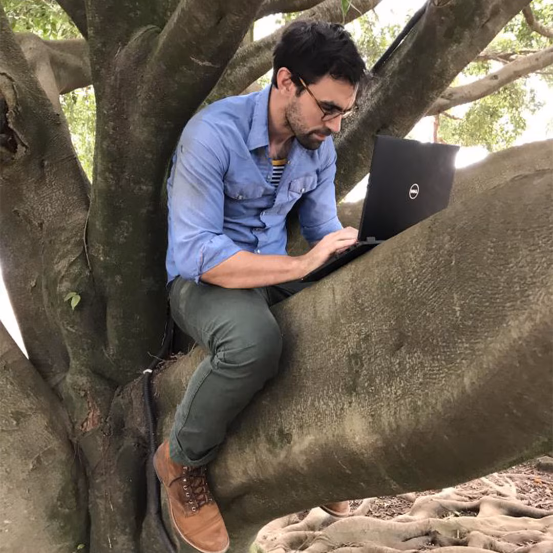 eis-promo-ig-2020-1080px EIS officer sits in a tree in Goma, Democratic Republic of Congo, working on the Ebola response in 2019.
