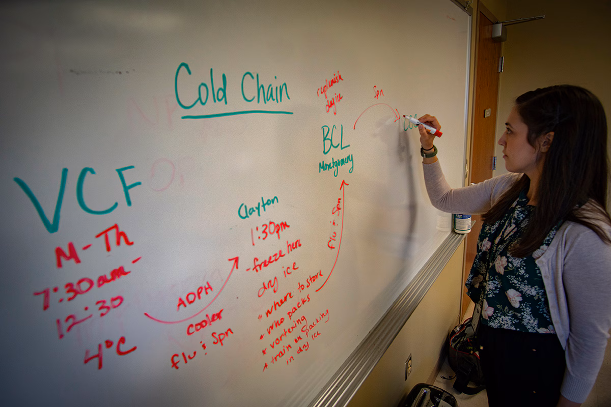 nicole-brown-epi-aid EIS officer writes notes on a whiteboard.