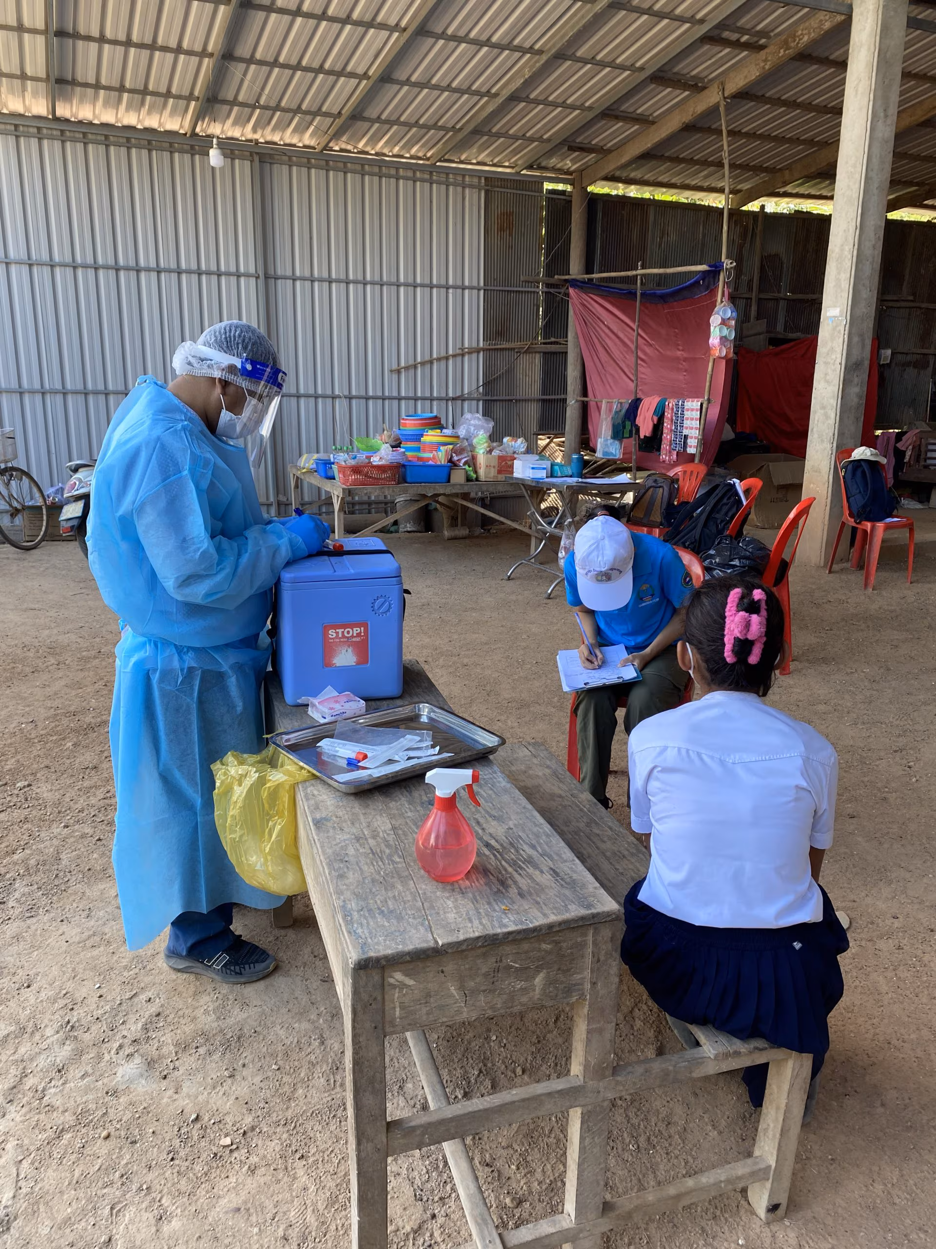 Swabbing close contacts in Cambodia, February 2023 Swabbing patients while wearing PPE