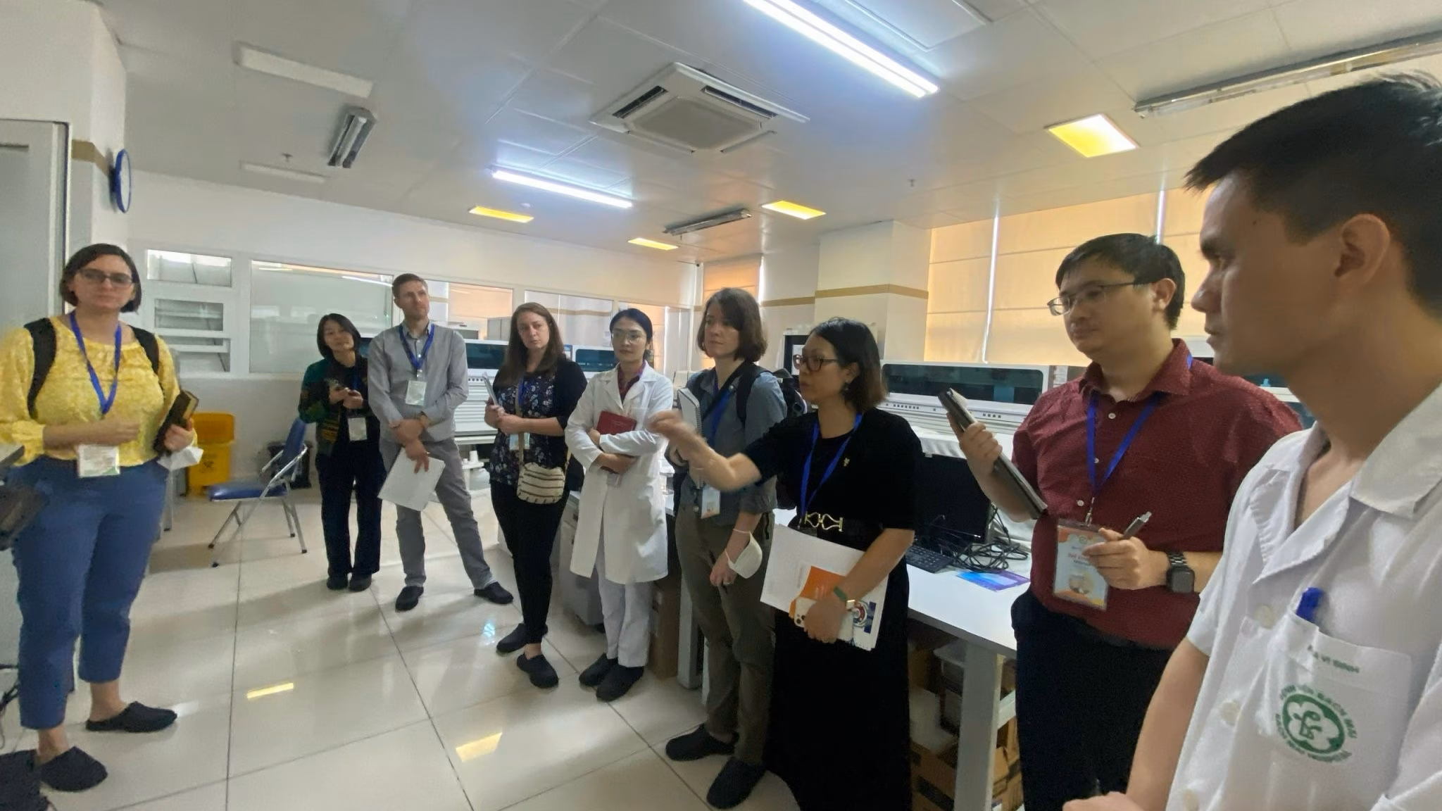 Stories-Vietnam Genome Sequencing A group of men and woman standing in a room