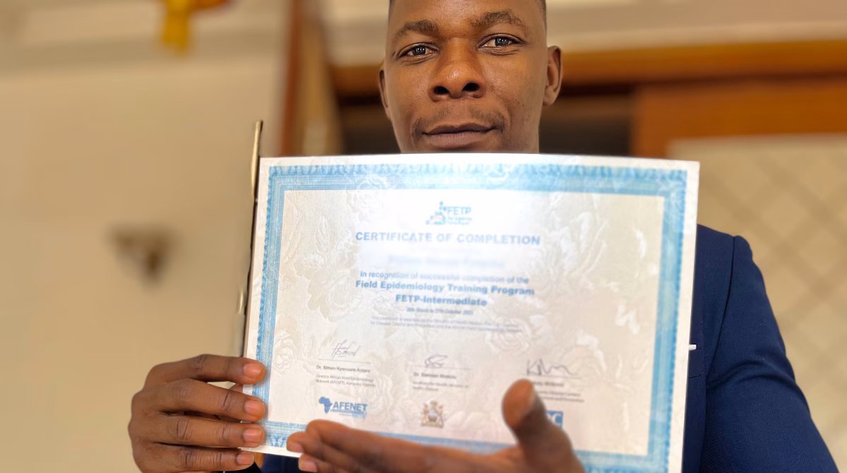 FETP Certificate Man holds a training certificate from the Field Epidemiology Training program.