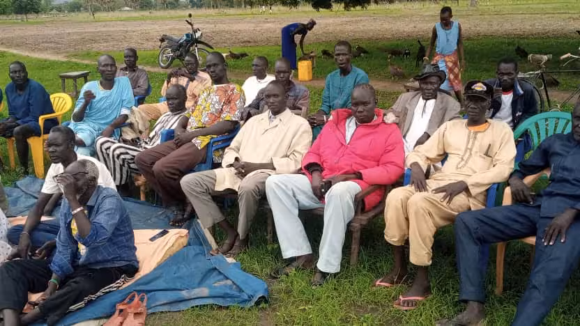 SouthSudan_CommunityOutreach_Photo_002 A group of people are seated outdoors.