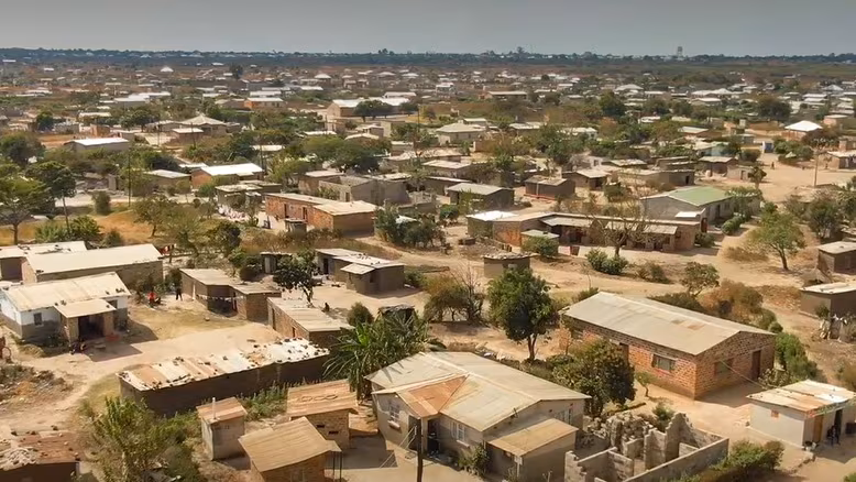 — title missing — This image shows an aerial view, with houses, trees, and roads, in Lusaka, Zambia.
