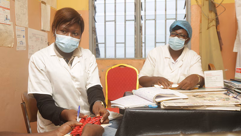 CDC supports Cameroon to ensure delivery of quality HIV/TB during COVID-19_005 Two health care workers provide HIV treatment pills