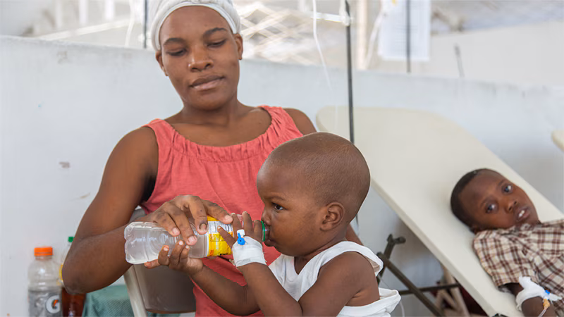 Cholera Response Work in Haiti_001 A young child receives oral rehydration therapy, a critical therapy, at a cholera treatment center in Haiti.