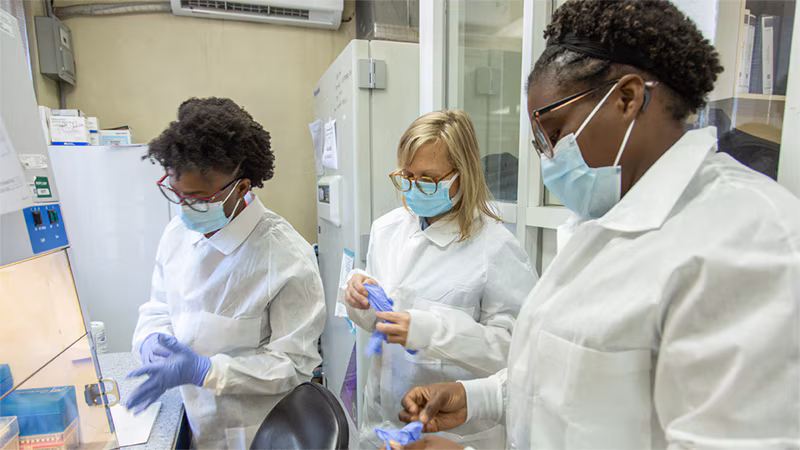Cholera Response Work in Haiti_002 CDC microbiologist Maryann Turnsek (center) works with staff at the molecular biology department of the National Public Health Laboratory of Haiti to enhance the laboratory's ability to detect and respond to cholera cases.