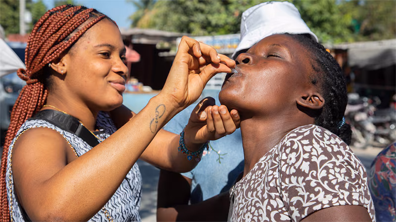 Cholera Response Work in Haiti_003 A healthcare worker administers an oral cholera vaccine to a patient.