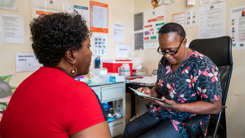-- title missing -- Patient and clinician discuss brochure in an office.