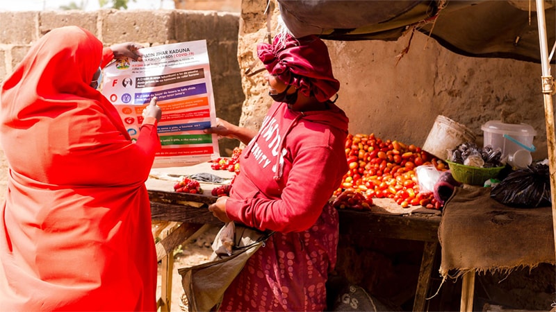 CDC and Nigeria partner to increase COVID-19 vaccination_002 Community volunteers go to markets and other meeting points to hand out flyers and informational sheets on how to prevent COVID-19