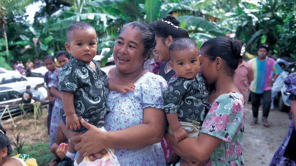 Island Health Program Two women in an island setting with their young children.