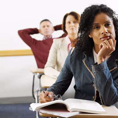 adult students paying attention in class Adults learning about health in an adult education classroom.