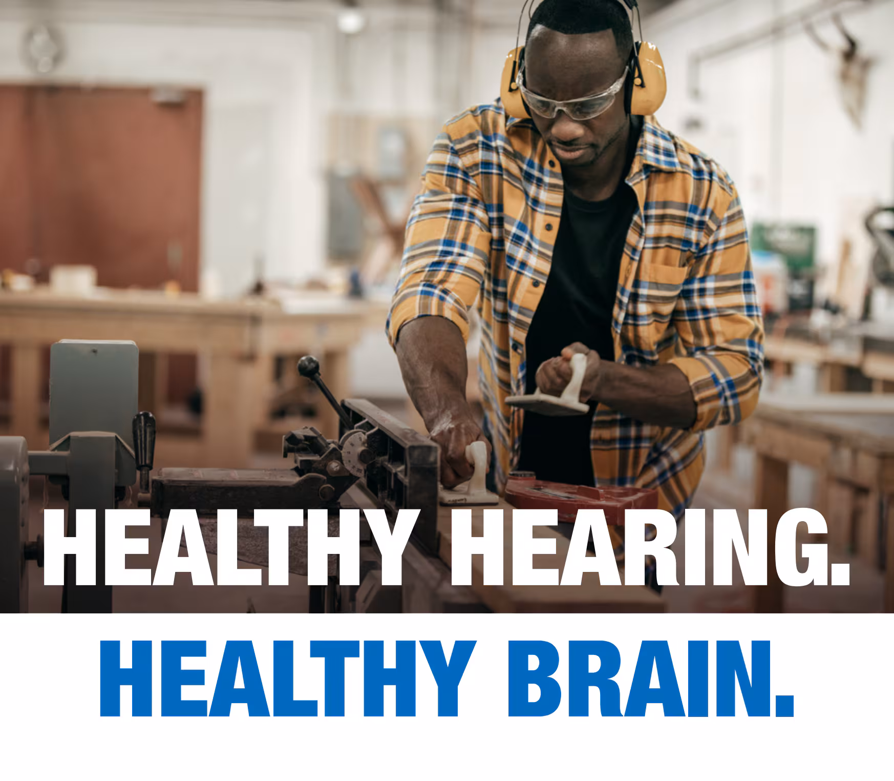 Healthy Hearing. Healthy Brain. African-American man woodworking in a shop. Text: Healthy Hearing. Healthy Brain.