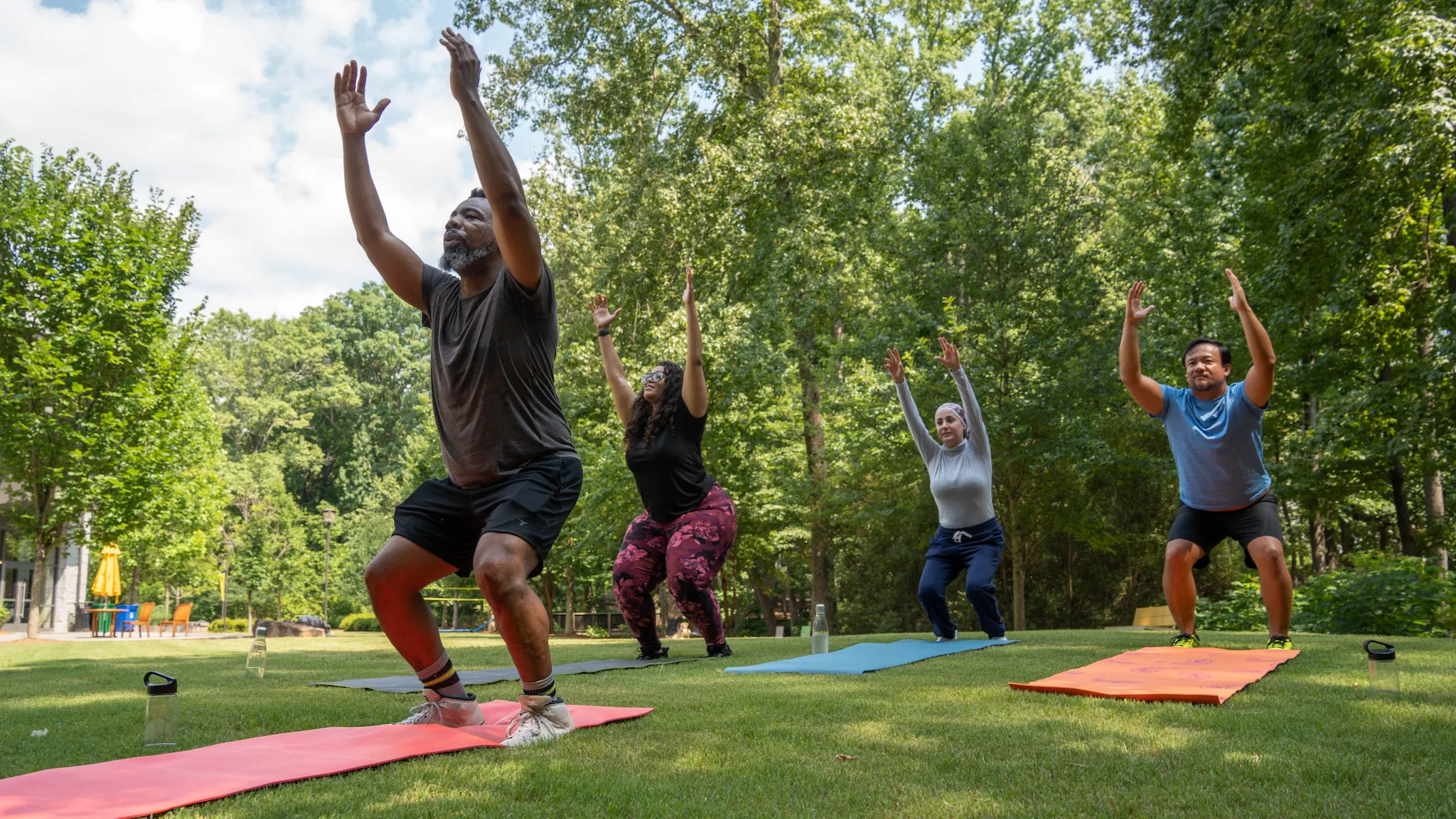 People doing yoga in the park People doing yoga in the park