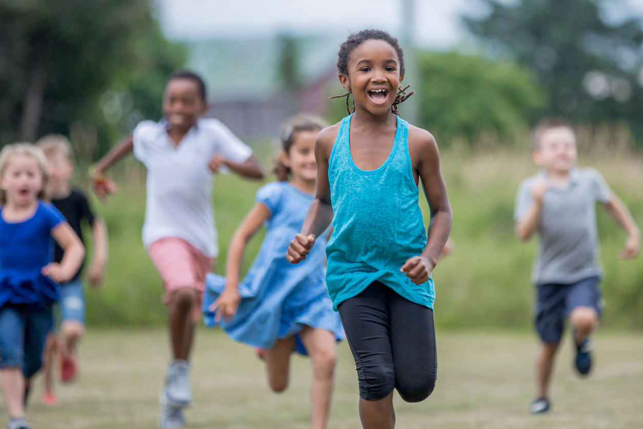 Children running a park after school.