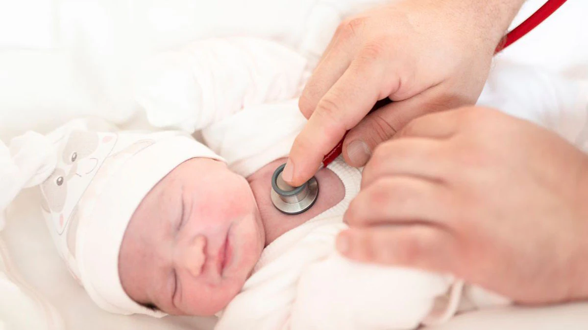 Listening to heart with stethoscope A healthcare professional listening to a baby's heart with stethoscope