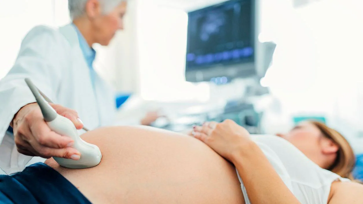 A pregnant woman getting an ultrasound A pregnant woman getting an ultrasound