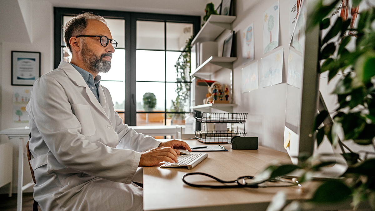Recommendations for Hepatitis C Screening for Children and Infants Doctor sitting at a desk reviewing hepatitis c testing recommendations for perinatally exposed infants and children