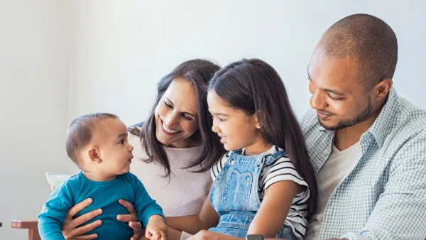 adoptionhealthguidancemedium.jpg Family playing with baby