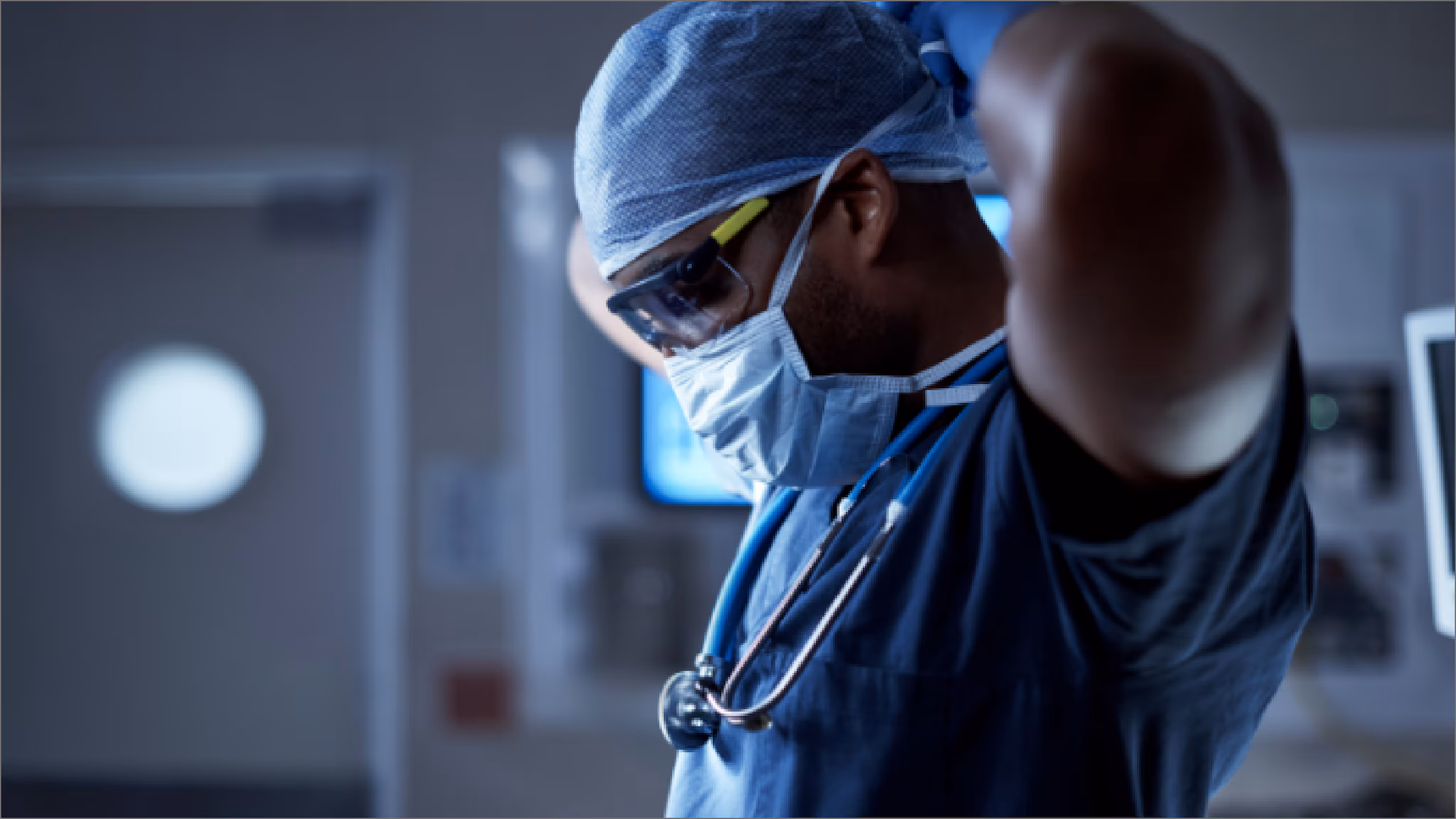 Physician Putting on personal protective equipment in a healthcare setting