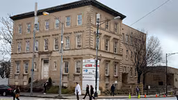 Brown brick building in winter with grey sky