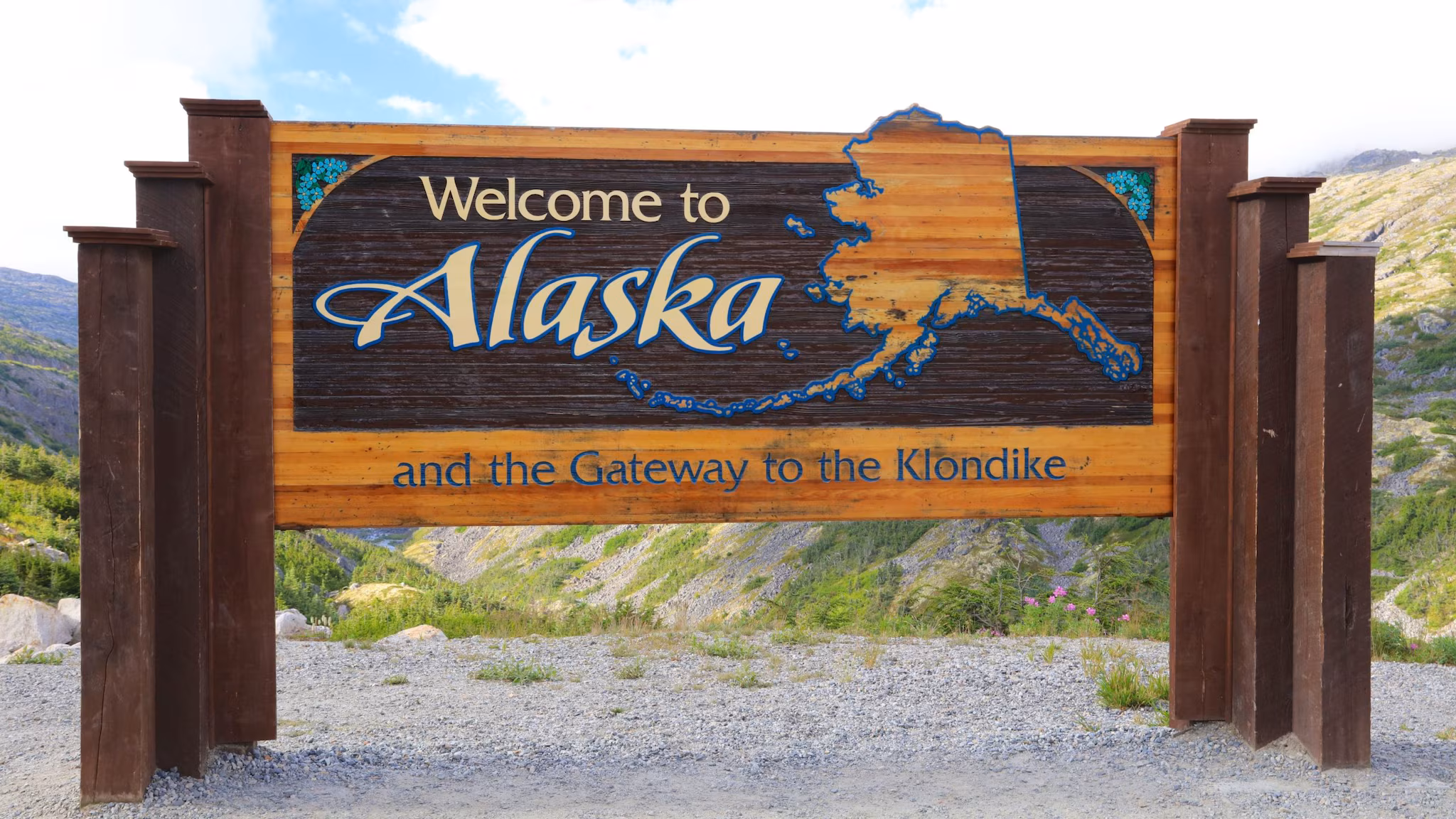Decorative roadside sign states welcome to Alaska