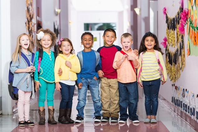 Young kids in school hallway Young kids stand in a school hallway.