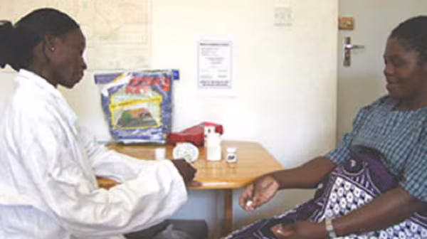 Pregnant woman receiving treatment from a healthcare provider.