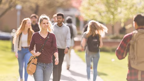 College student walking College students walking on the sidewalk to class.