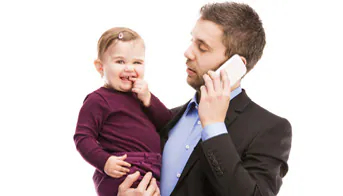 Early Intervention Contacts Man holding phone and baby