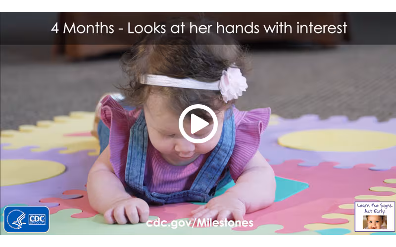Looks at her hands with interest