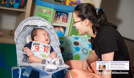 Mom playing with baby smiling
