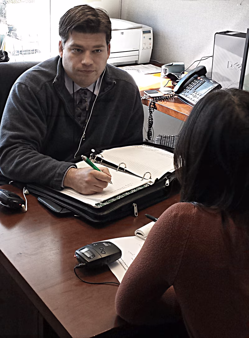 Justin meeting with colleague in his office.