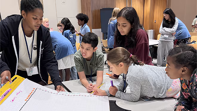 2024 Data Detectives Atlanta - 1 Students looking at a chart that the instructor is showing.