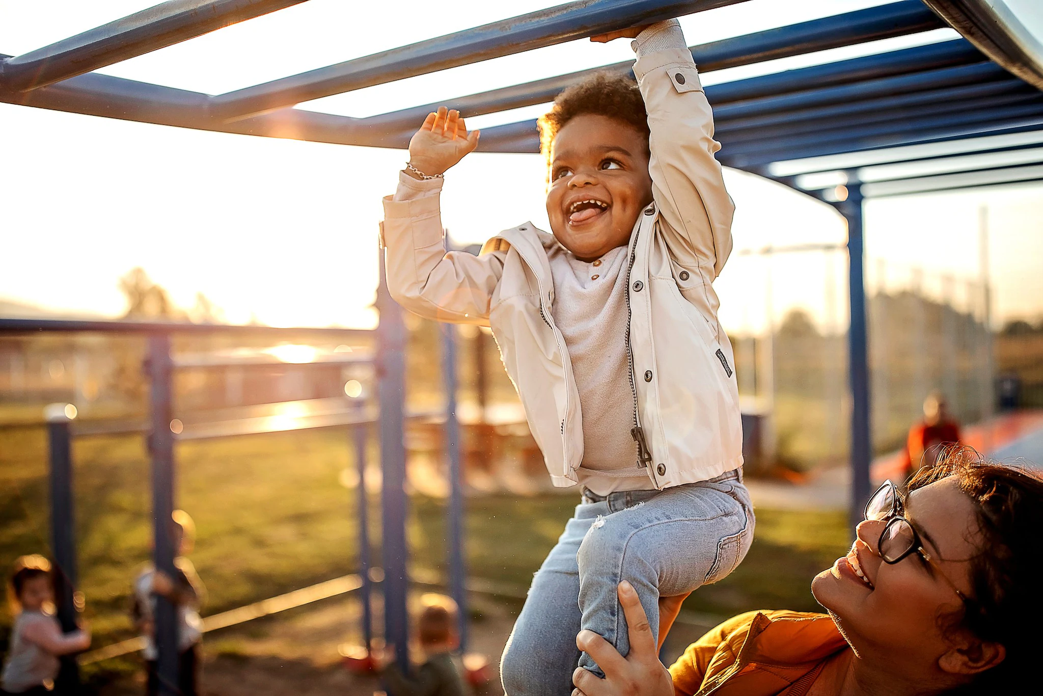 Happy child and mom Happy child plays on playground with mom