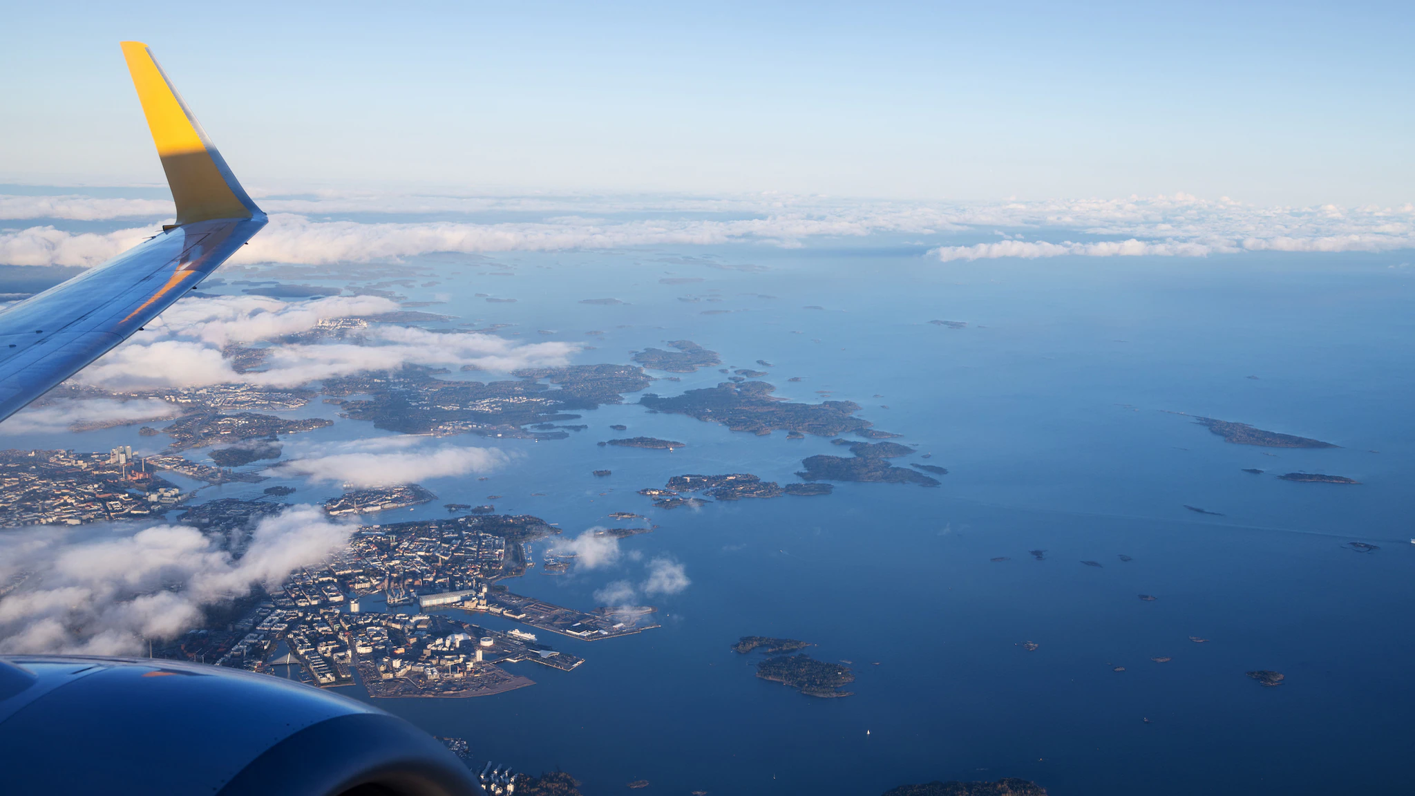 1870231460 Helsinki Seaport and the Gulf of Finland from an airplane window during takeoff.