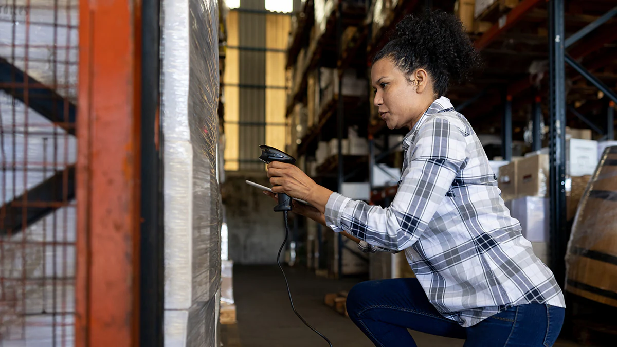 NIOSH enews July DD Blackwoman wearing a checkered shirt working on a machine.
