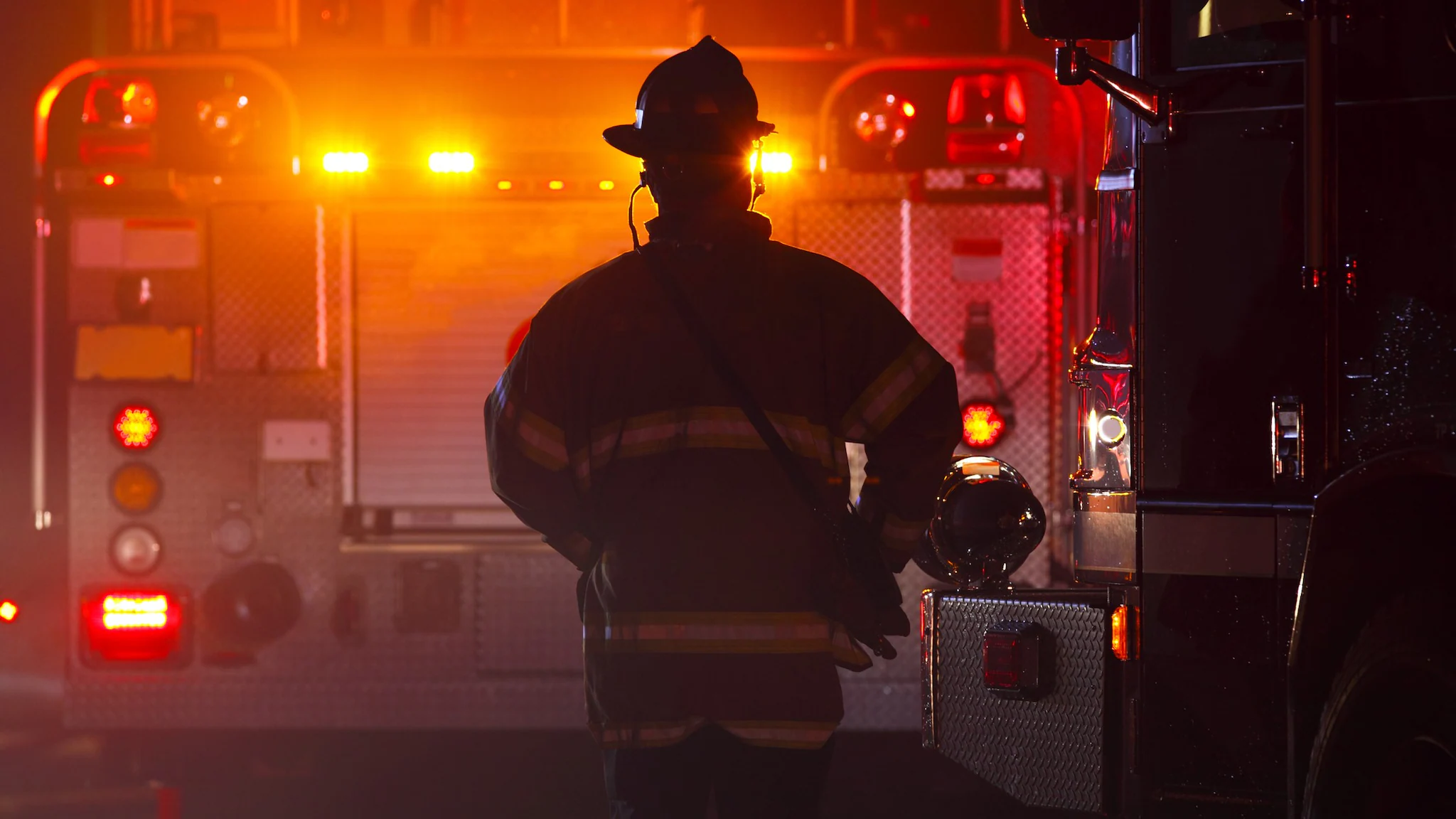 FFFIPP_Thumbnail A firefighter walks towards a firetruck.