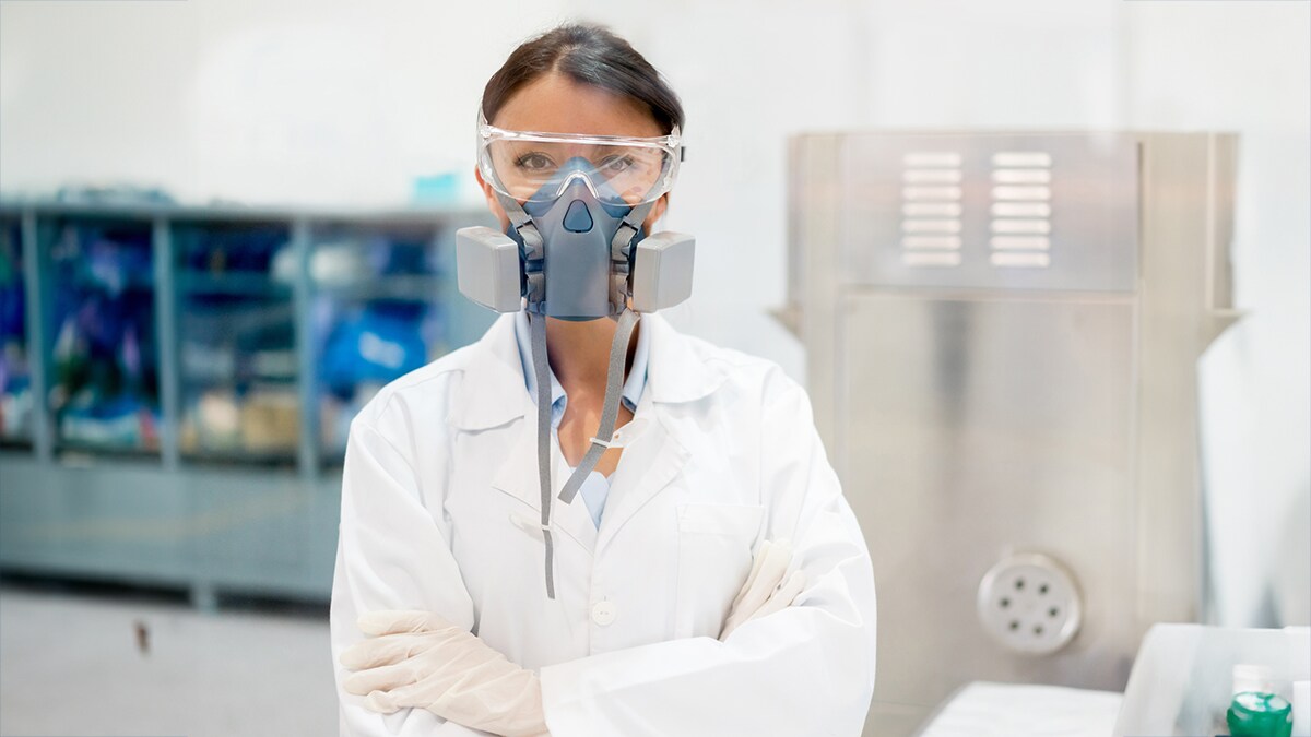 NPPTL DIv page Woman in white coat wearing PPE
