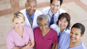 -- title missing -- Group of healthcare workers smiling for picture.