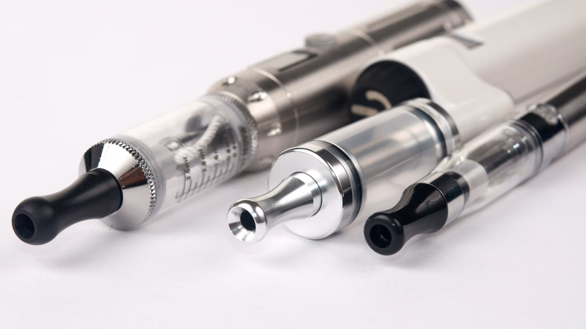 — title missing — Three different vape products line up.